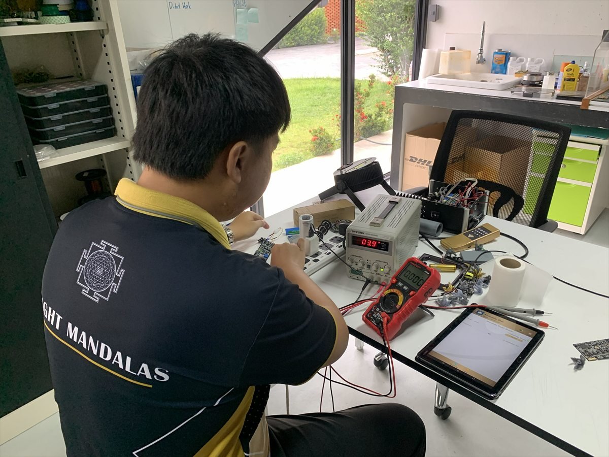 Light Mandalas team member testing electronic product components