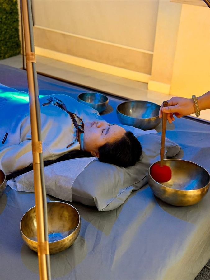 Devessa wellness session with sound bowls and soft light