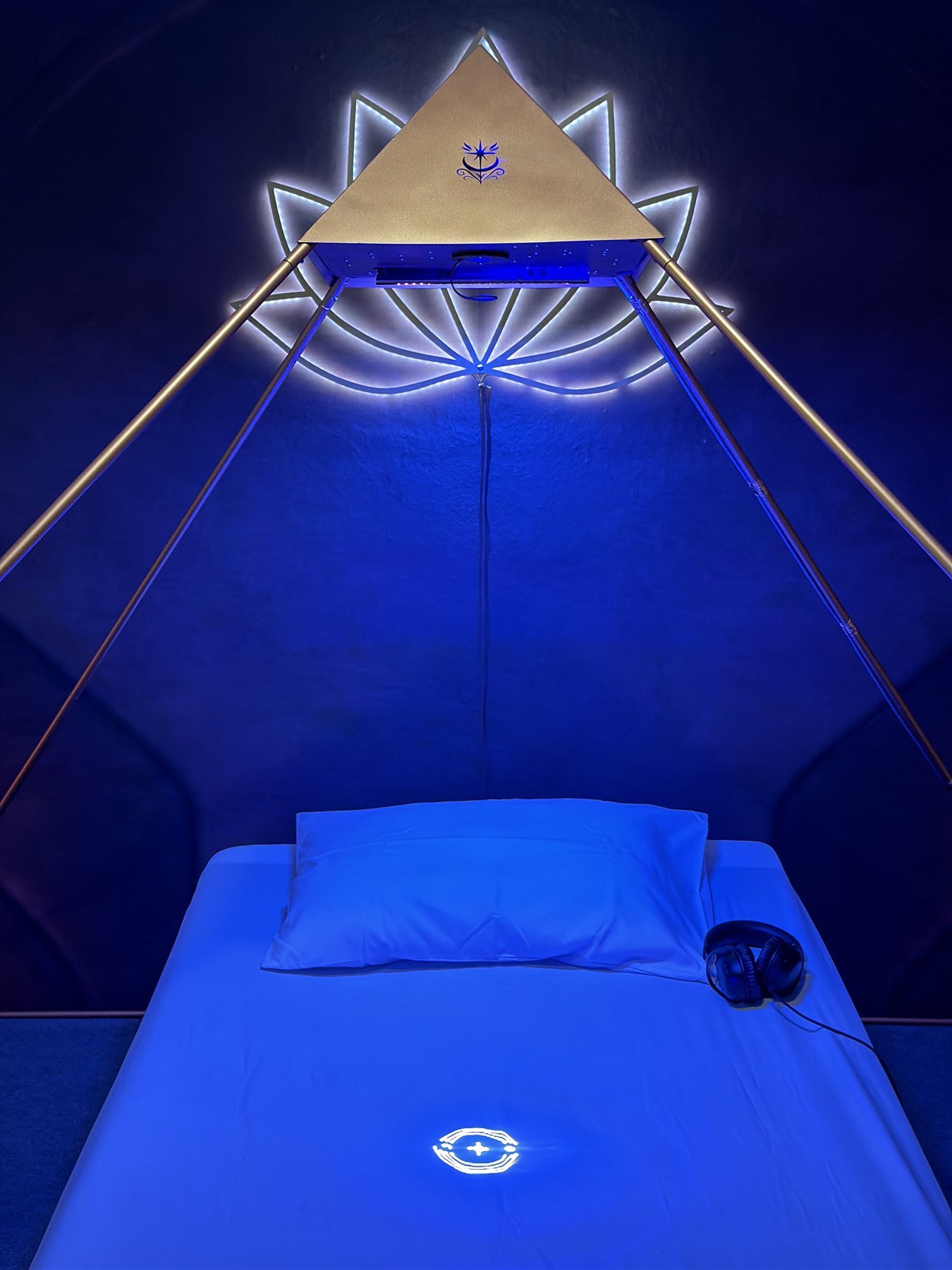 Geometric light symbol projected beneath the Luminara Pyramid