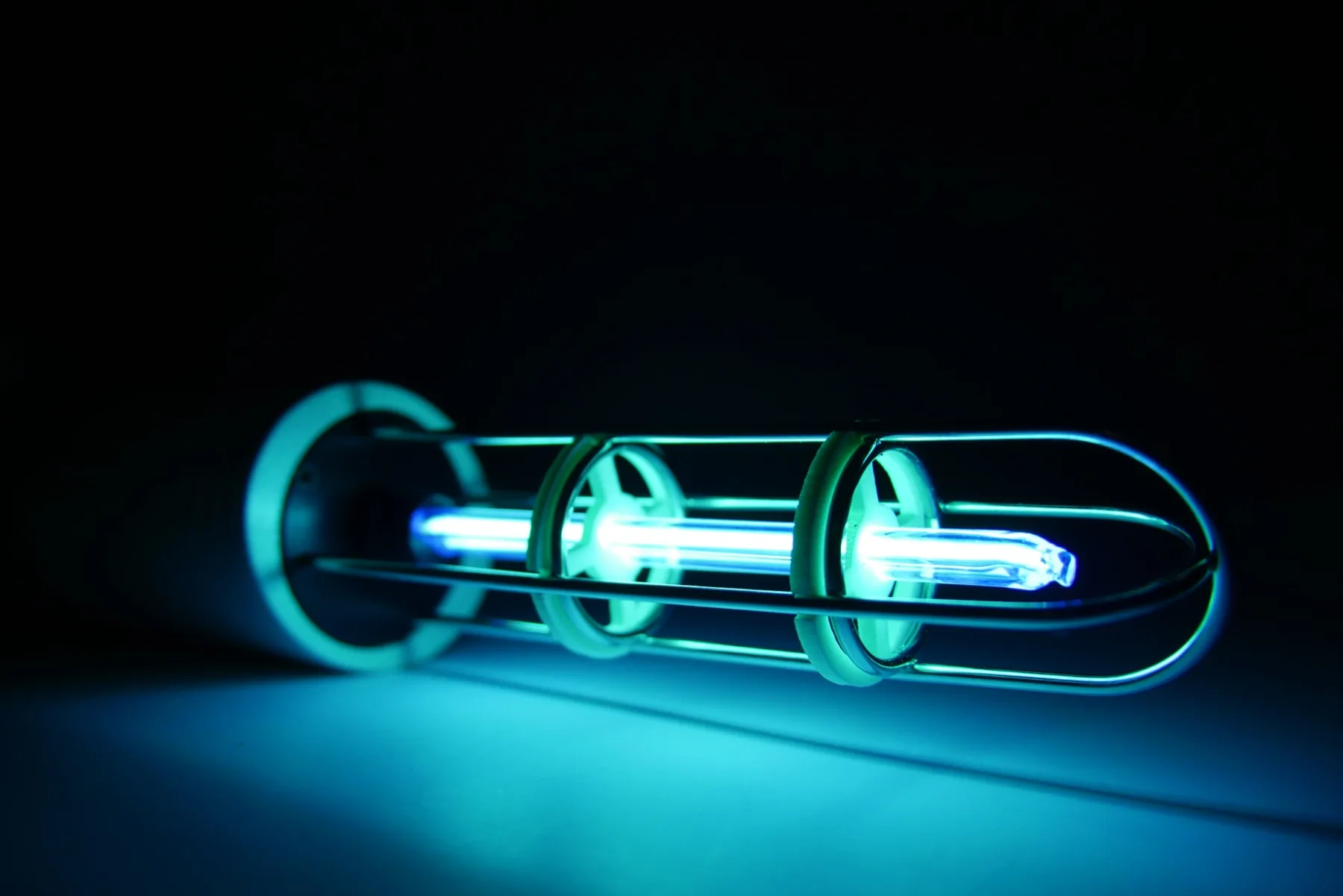 Violet Shield plasma tube glowing blue and violet in darkness